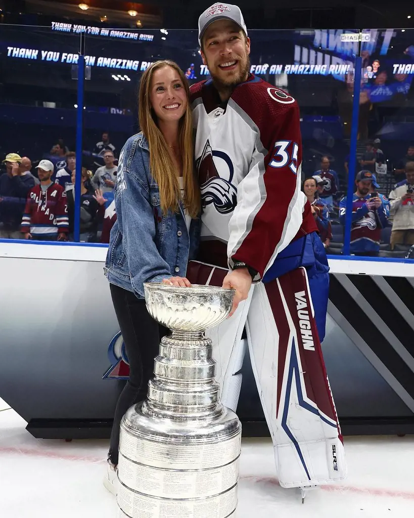 Kuemper with his wife Sydney posing with the Stanley Cup