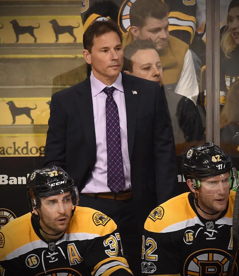 Cassidy standing on the Boston Bruins's team side when he served as head coach for the team
