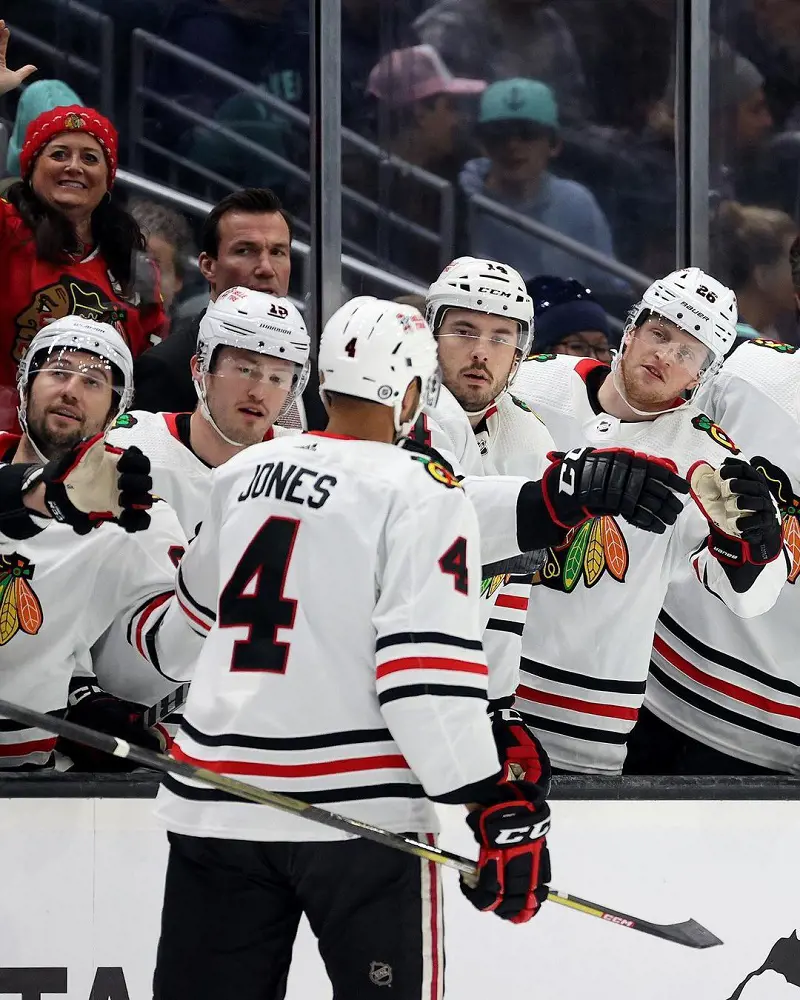 The Blackhawks players cheering the roster from the bench