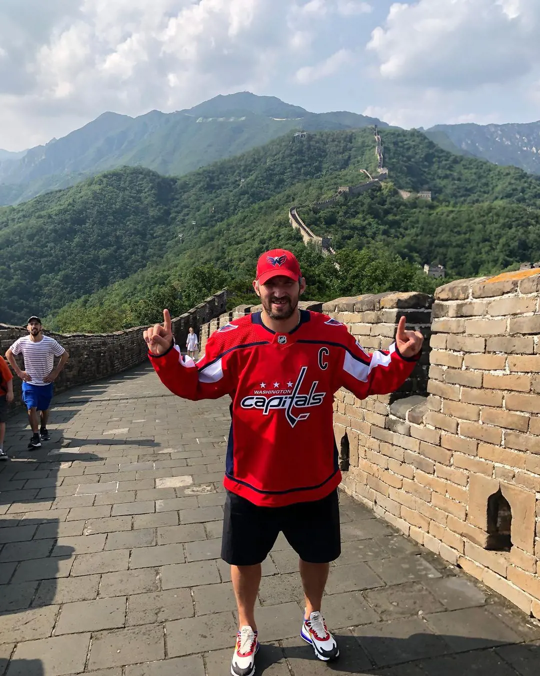 Alexander wearing The Capitals attire while exploring the Great Wall of China
