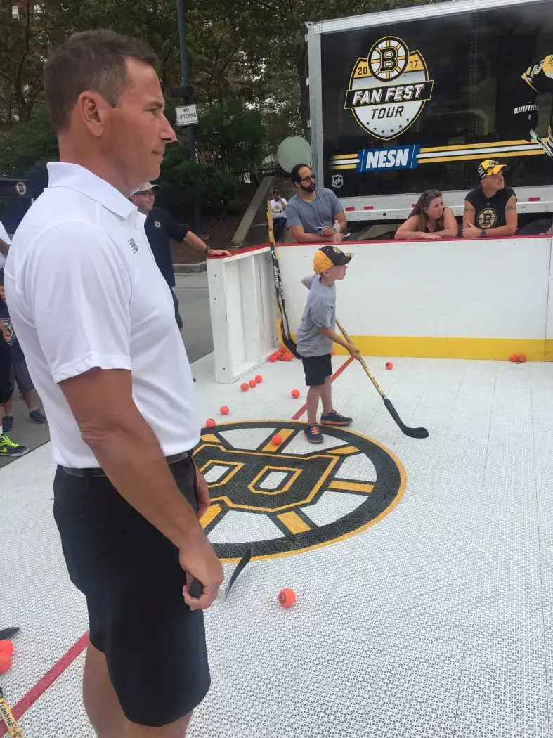 Head Coach Casidy helping teach kids onthe rink while in Boston Bruins Tour..